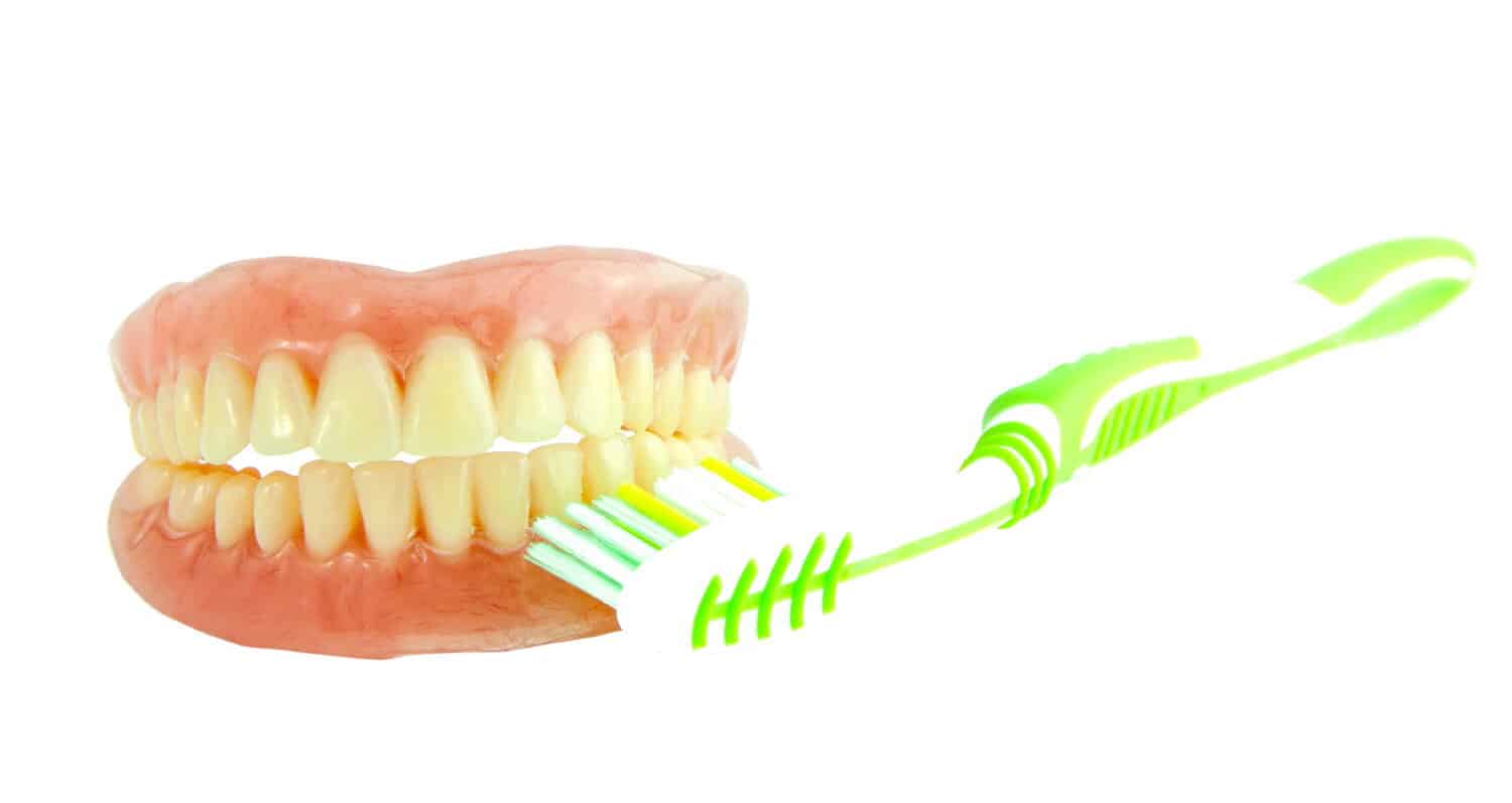 brushing dentures